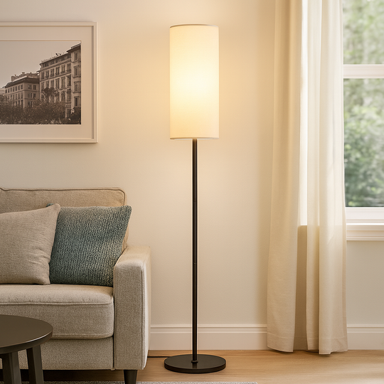Tall slim floor lamp with cylindrical fabric shade and black base, 173 cm in height, shown beside a modern chair in a living room setting.