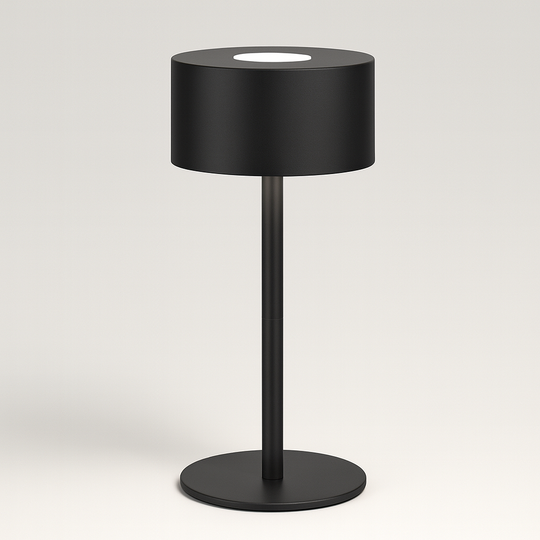 Modern black table lamp with cylindrical shade and slim stand, minimalistic design on a neutral studio background.