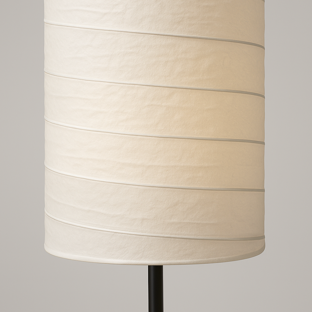 Tall cylindrical floor lamp with white fabric shade and black base, 107 cm in height, softly glowing with multiple light points.