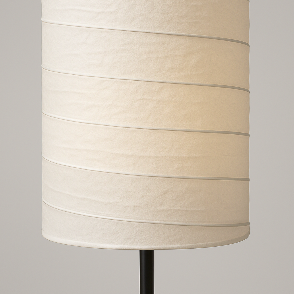Tall cylindrical floor lamp with white fabric shade and black base, 107 cm in height, softly glowing with multiple light points.