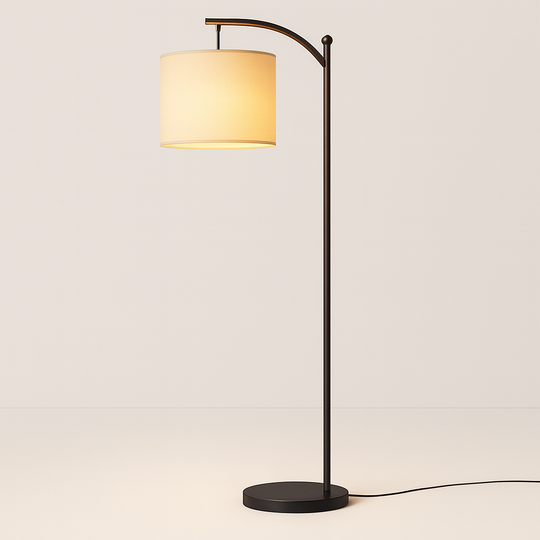 Tall arched floor lamp with black stand and ivory cylindrical shade, 158 cm in height, positioned beside an armchair in a cozy living room setting.